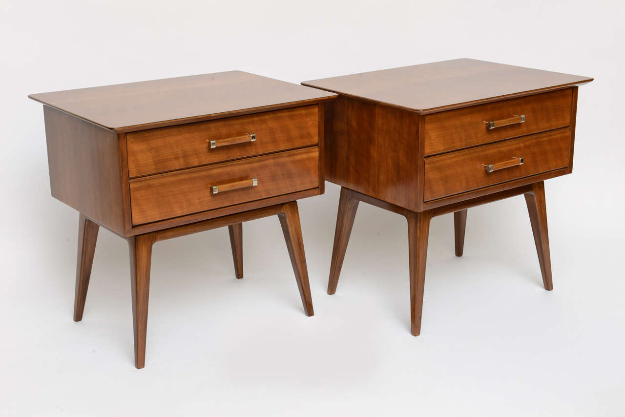SOLD  Beautifully figured cherry wood throughout highlights this pair of nightstands or bedside tables designed by Renzo Rutili for Johnson Furniture and deftly restored.  Great two drawer storage night tables.

50s modern lines, sculptural